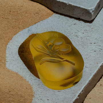 a yellow soap sitting on top of a cement slab