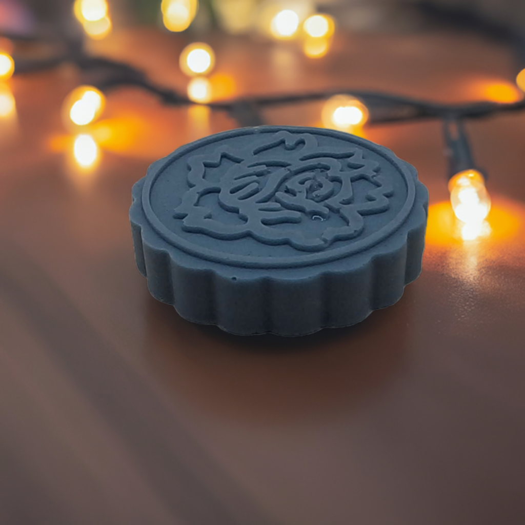 a wax stamp sitting on top of a wooden table