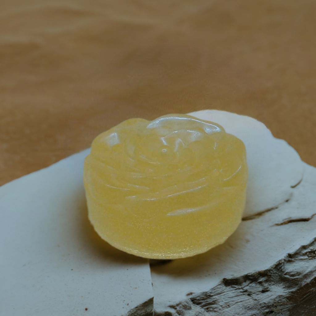 a piece of yellow soap sitting on top of a rock