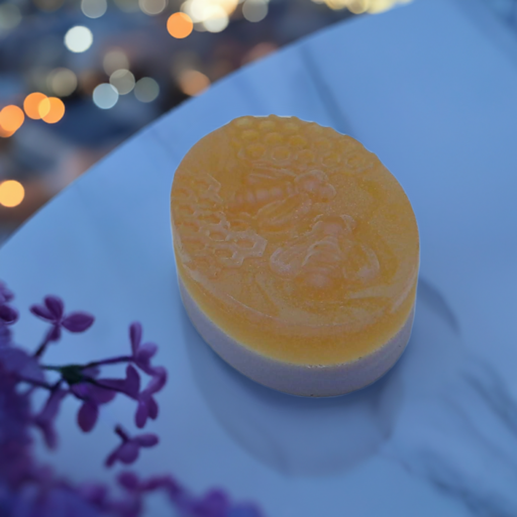 a round yellow soap sitting on top of a white table